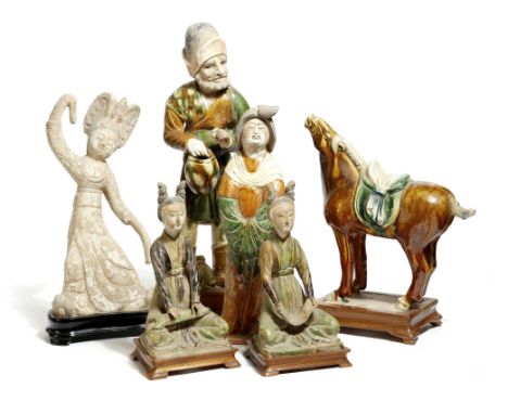 Six Chinese pottery figures in Tang and Han dynasty style, five with a lead glaze, comprising; a man with a basket and a dog,