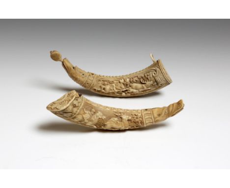 λ  Two similar 19th century Austrian hippopotamus tooth powder horns, one carved with a stag hunt, the verso with scrolling a