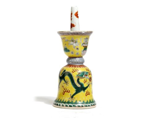 A Chinese porcelain altar candlestick, painted in coloured enamels, with a pair of dragons chasing a pearl, and with a scroll