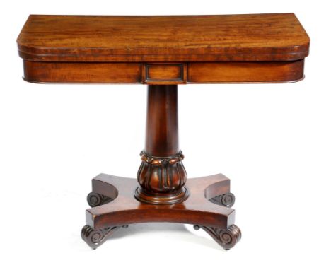 A William IV mahogany card table, the swivel fold-over top above a plain frieze centred with a tablet, on a lappet carved ste