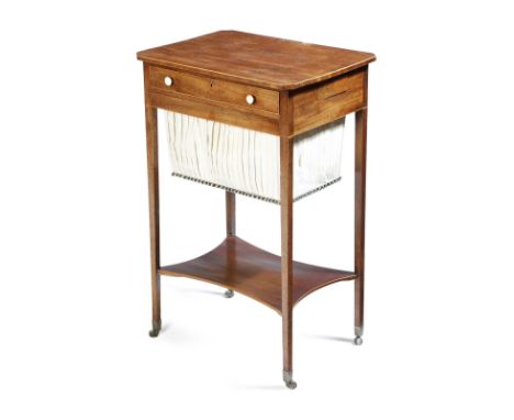 A George III mahogany work table, inlaid with boxwood stringing, the top with canted corners, above a divided frieze drawer a