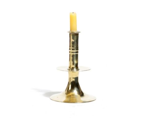 A Charles II brass trumpet candlestick, with fluted bands to the upper stem, above a drip-tray and a plain spreading foot, 14