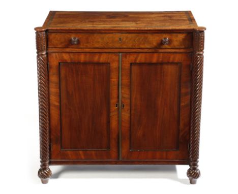 A Regency mahogany side cabinet, the banded top above a frieze drawer, above a pair of panelled doors enclosing a shelf, flan