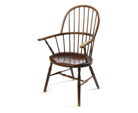 An ash and fruitwood Windsor lowback armchair, with a hooped stick back, on stretcherd supports, the seat rail stamped 'B', e