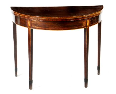 A George III mahogany demi-lune card table, the crossbanded fold-over top on a single gate support, on fan paterae headed squ