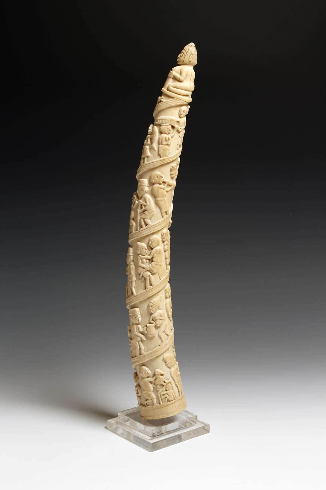 λ A 19th century African Loango ivory tusk, carved with a procession of