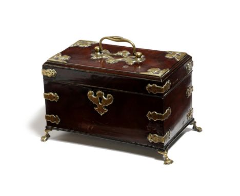 An early George III mahogany and brass mounted tea caddy, the hinged lid with a swing handle, revealing a vacant interior on 