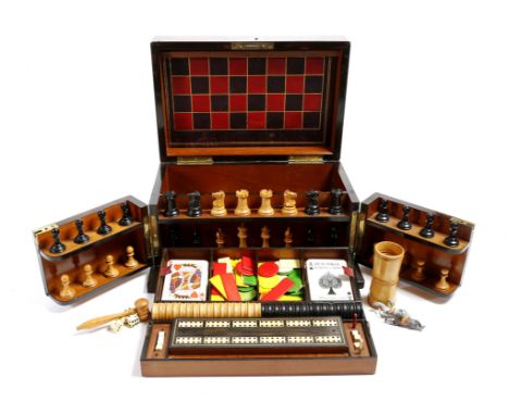 A Victorian coromandel games compendium, the interior with two lift-out trays, fitted with boxwood and ebony draft pieces, a 