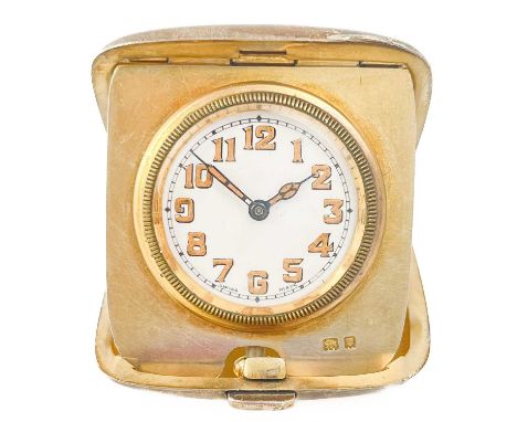 A silver engine turned manual wind travel watch.  The 25mm white dial with luminous Arabic numerals and luminous hands, unsig