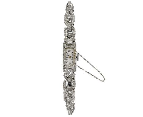 An Art Deco platinum and diamond lady's cocktail bracelet wristwatch.   The rectangular silvered 9mm dial with Arabic numeral