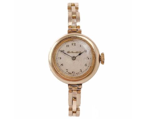 An early 20th century 15ct gold lady's bracelet wristwatch. The 20mm silvered dial signed Thos Russell &amp; Son, Swiss movem