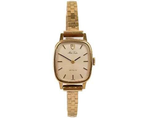 A Tudor 'Miss Tudor' 9ct gold lady's manual wind bracelet wristwatch. The 17mm signed silver dial with gilt baton markers, si