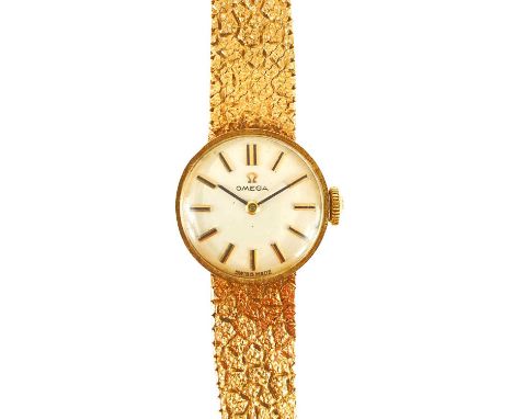 An Omega 9ct gold lady's manual wind bracelet wristwatch. Cal. 483, with signed 16mm silvered dial with gilt baton markers, 1