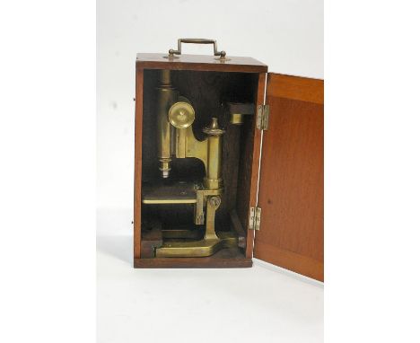 A brass microscope, by Watson &amp; Sons, stamped, with swing handle, overall 33cm high x 19.5cm wide x 13.5cm deep