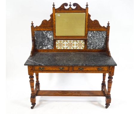 A 19th century pitch pine wash stand with decorative shaped back with broken pediment above a square mirror and tile motif an