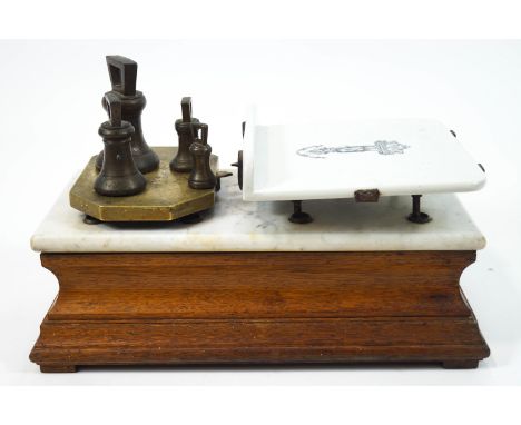 A Shop scales, with weights to a brass plate, married with a china balance, decorated with a transfer figure raised on a whit