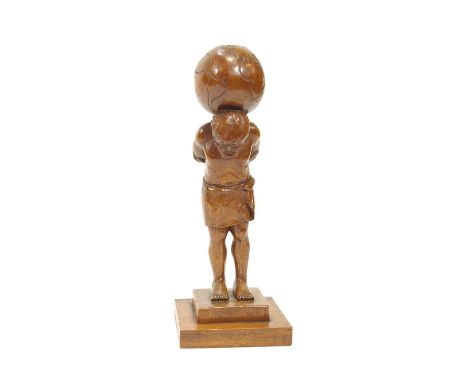A carved table lamp in the form of an Atlas on a stepped base, 41cm high