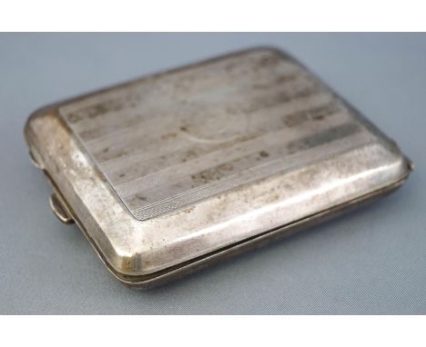 An Art Deco silver rectangular form engine turned decorated cigarette case, with unusual dispensing mechanism, Birmingham 192