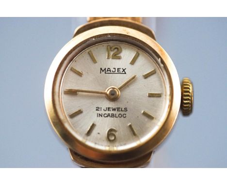 A yellow metal Majex wristwatch. Round silver dial with baton markings. Manual wind movement, 21 Jewels. Case reference: 6845