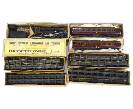 A Bassett - Lowke '0' gauge steam engine train set comprising of model Express Locomotive and tender (boxed) and two LMS coac
