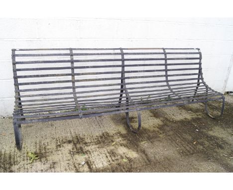 A long wrought iron garden bench