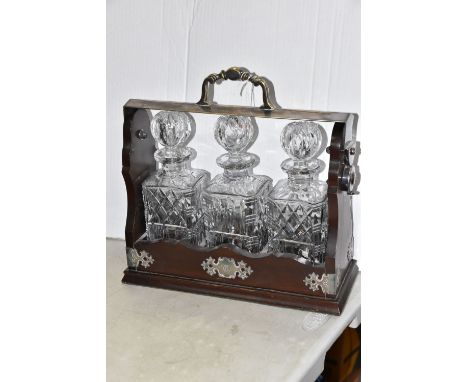 A THREE DECANTER TANTULUS, with silver plated mounts and monogrammed plaque, the locking frame accommodating three clear cut 