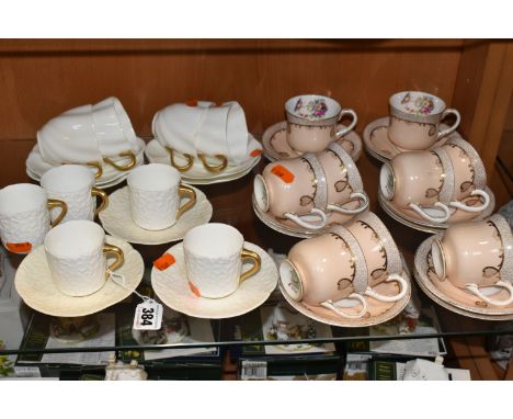 A GROUP OF AYNSLEY AND COALPORT TEAWARE, comprising six white textured Coalport coffee cans with gilt handles and three sauce