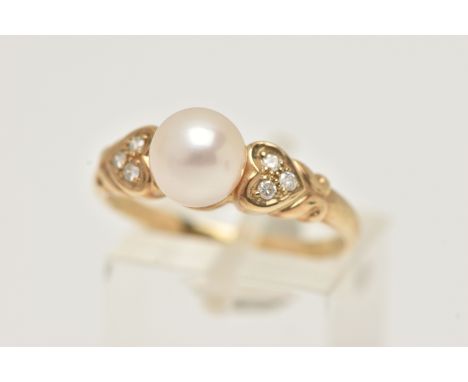 A 9CT GOLD CULTURED PEARL AND DIAMOND RING, set with a single cultured white pearl, measuring approximately 7.2mm, flanked wi