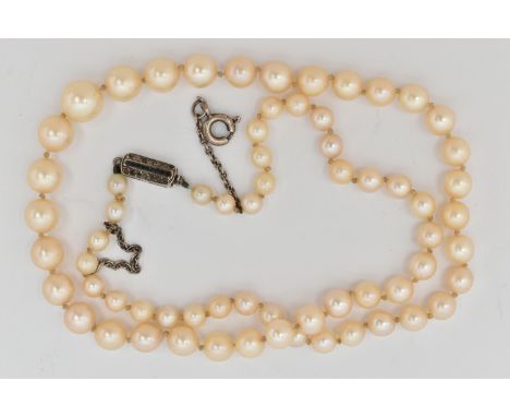 A CULTURED PEARL NECKLACE, a single row of graduated cream pearls, individually knotted on a white cord, fitted with a white 