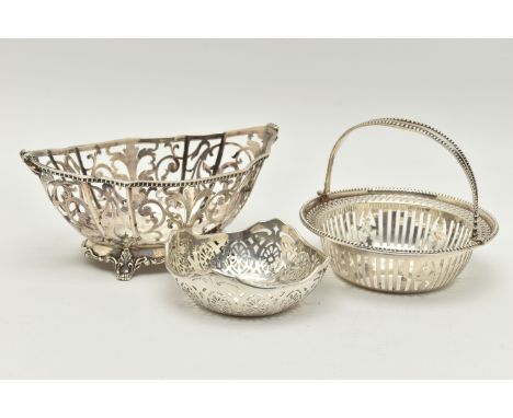 THREE EARLY 20TH CENTURY PIERCED SILVER BONBON DISHES/NUT DISHES, comprising a George V circular swing handled dish with bead