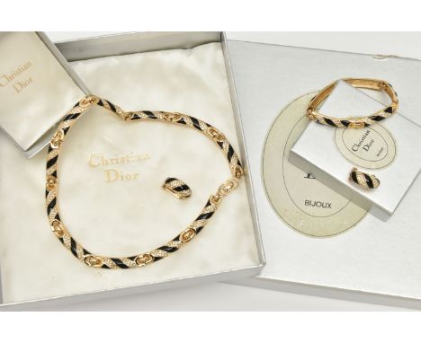 A THREE PIECE 'CHRISTIAN DIOR' SET, to include a necklace, bracelet and clip on earrings, gold plated with black enamel and s