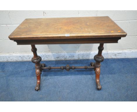 A VICTORIAN BURR WALUT CARD TABLE, the swivel fold over top, enclosing a green baize playing field, turned supports, raised o