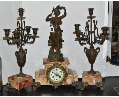 A FRENCH ROSE MARBLE CLOCK GARNITURE, clock supporting a bronzed figure of a woman 'Rayon De Soleil' plaque beneath, enamel d