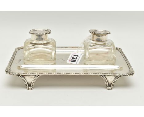 A LATE VICTORIAN SILVER INKSTAND OF RECTANGULAR FORM, foliate scroll and shell cast corners, reeded border, on four legs, bea