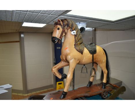 WOOD ANTIQUE STYLE ROCKING HORSE, height approximately 65cm, embossed leather look saddle, metal stirrups, metal wheels, moun