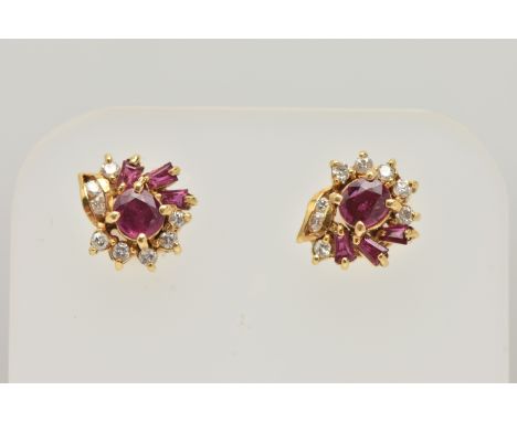 A PAIR OF YELLOW METAL RUBY AND DIAMOND EARRINGS, each designed as a cluster set with a central circular cut ruby, in a surro