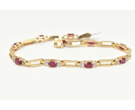 A YELLOW METAL RUBY AND DIAMOND LINE BRACELET, designed as a series of open work links, interspaced with links each set with 