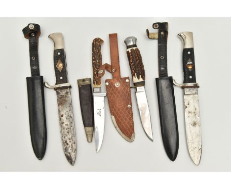 FOUR GERMAN DAGGERS WITH SCABBARDS, to include a C. Jul Herbertz of Solingen dagger with scabbard, missing shield inlay to th