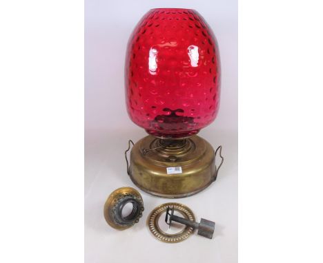 Early 20th Century oil lamp with cranberry glass shade. H.47cms and oil lamp fitting    Condition Report   Click here for fur