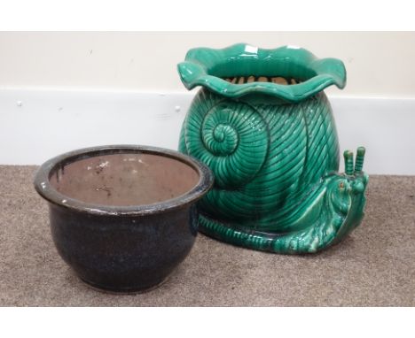 Glazed terracotta garden planter in the form of a snail and another glazed plant pot