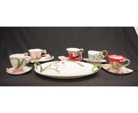Collection of Franz porcelain tea wares comprising 3 various cups &amp; saucers, a teaspoon, and a tray, all with in relief f