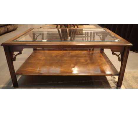 Glass topped large mahogany coffee table with under shelf