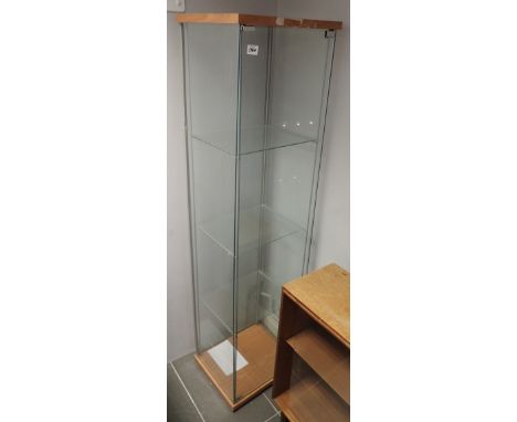 Two IKEA glass display cabinets with three shelves, one with interior lighting