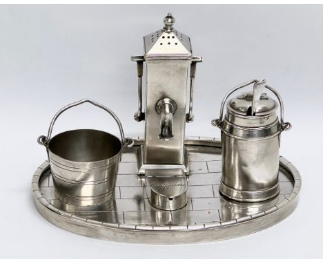 A 19th Century silver plated novelty condiment set/cruet set, in the form of a water pump, milk churn and bucket. On a paved 