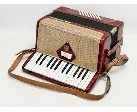 A Rigoletto II accordion with case.