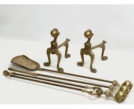 A Victorian style brass ball and claw andirons and fire tools.