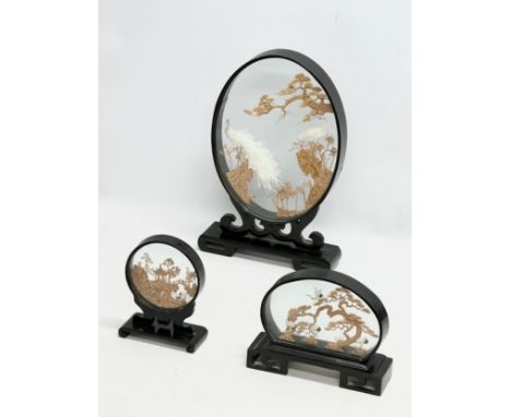 A set of 3 Mid 20th Century Chinese lacquered framed cork art displays. With cranes, pagodas, and trees. 24x36.5cm. 21x16cm. 