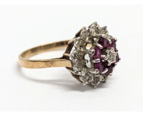 A 9ct gold diamond and ruby ring. Ring size UK K