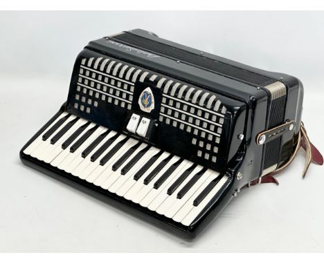 A Paolo Soprani accordion with case.