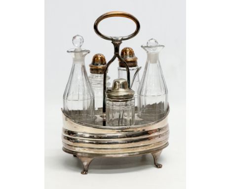 A large Late 19th Century Victorian cruet set. Silver plate on copper. Vinegar bottles, salt and pepper shaker and mustard po